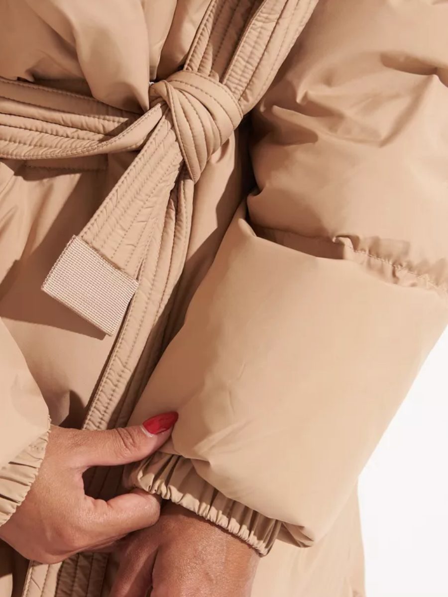 Close-up of the coat's padded sleeve, elastic cuff, and belt