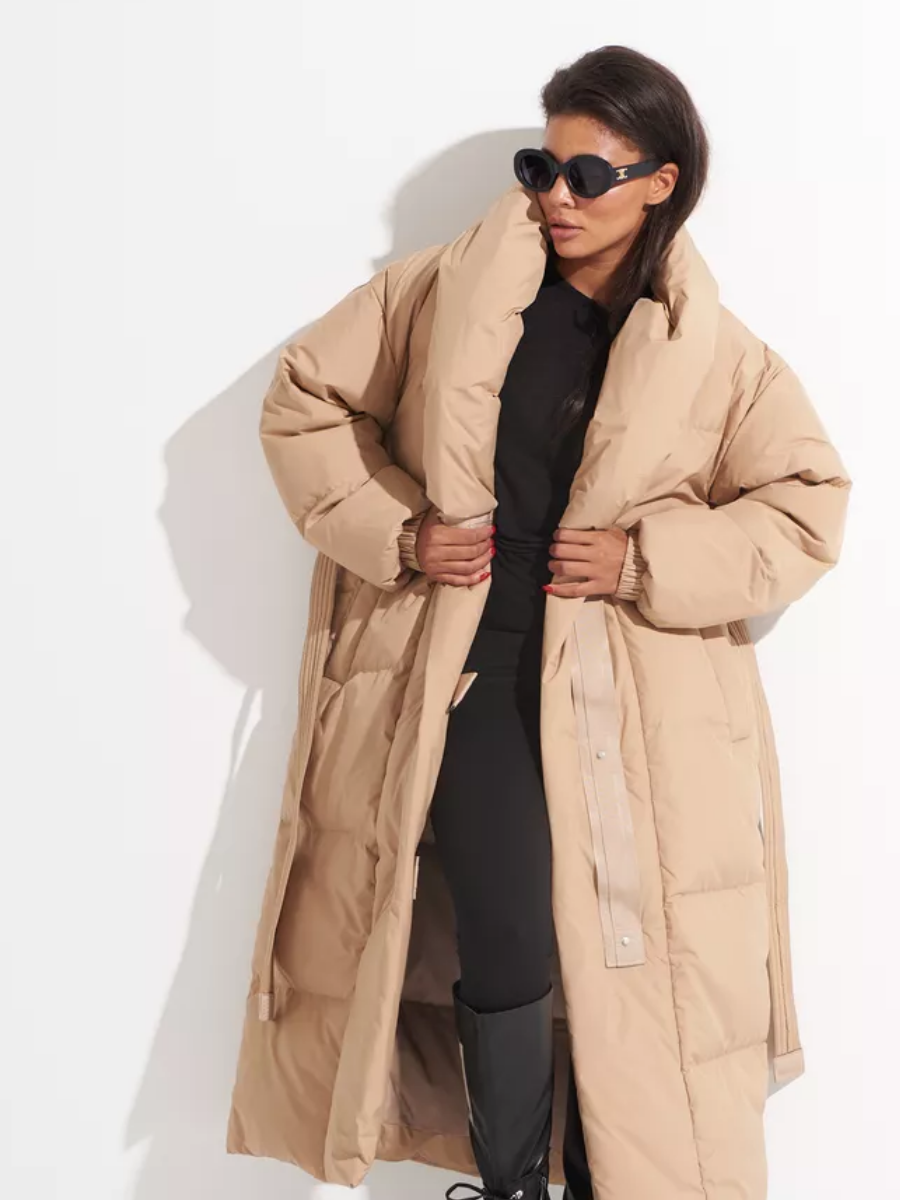Open long down coat showing its snap-front closure, quilted lining and large shawl collar.
