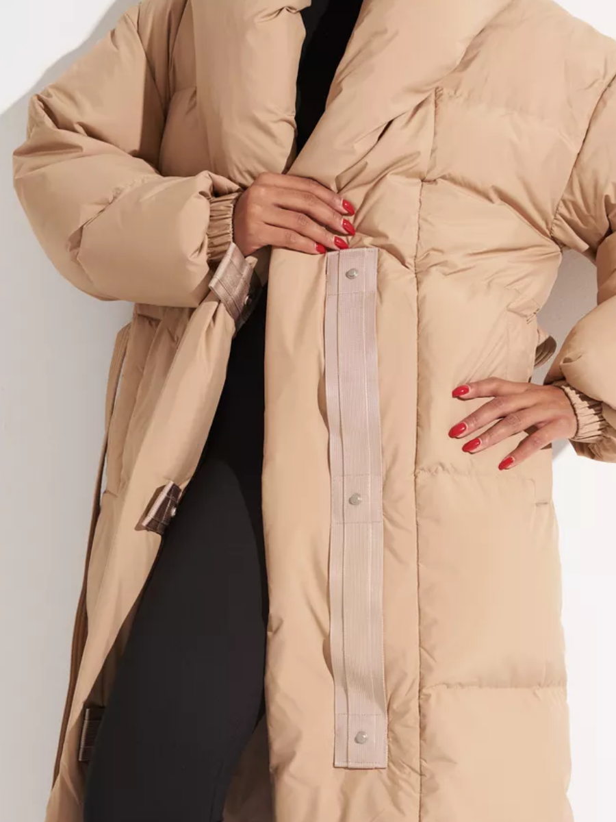 Open coat front showing the snap-fastening closure and quilted panels