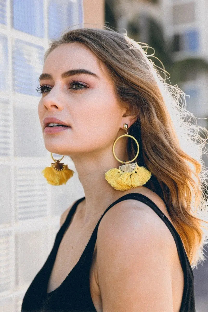 Gold hoop earrings with yellow fan tassels and drop design