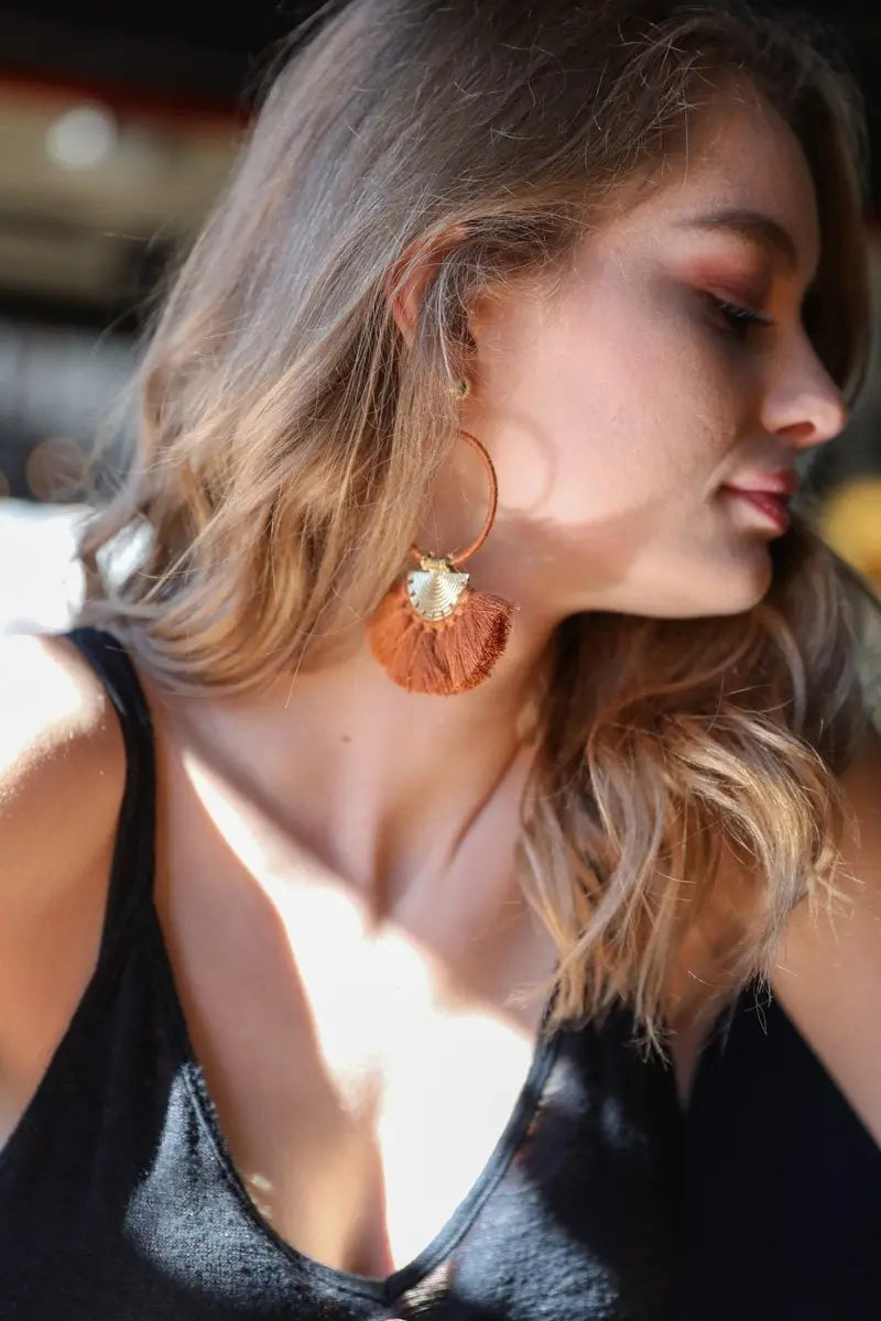 Gold hoop drop fan tassel earrings with orange-brown tassels