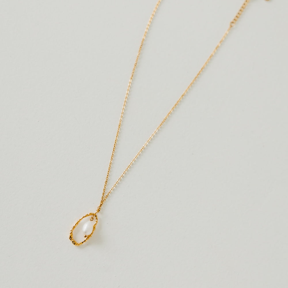 Gold-tone necklace with teardrop open-circle pearl pendant