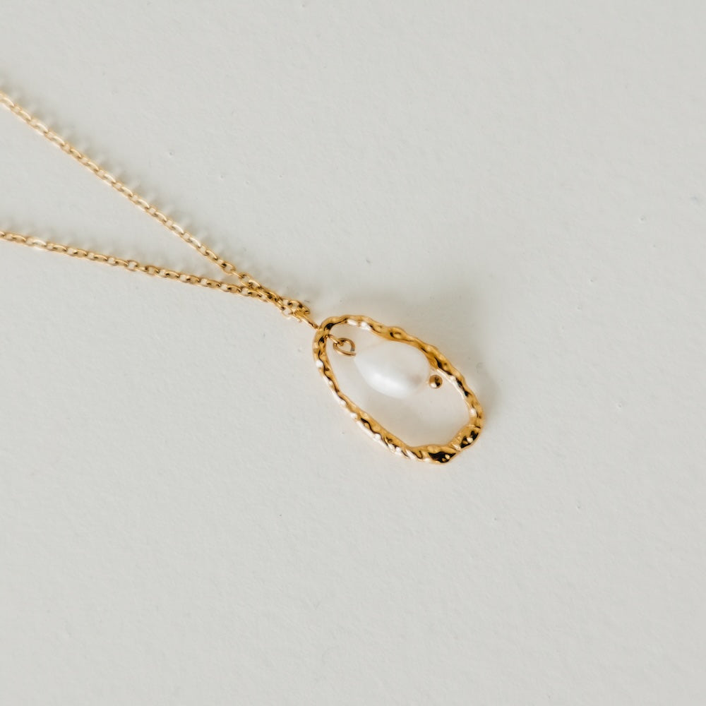 Gold-tone open-circle pearl pendant on thin chain necklace