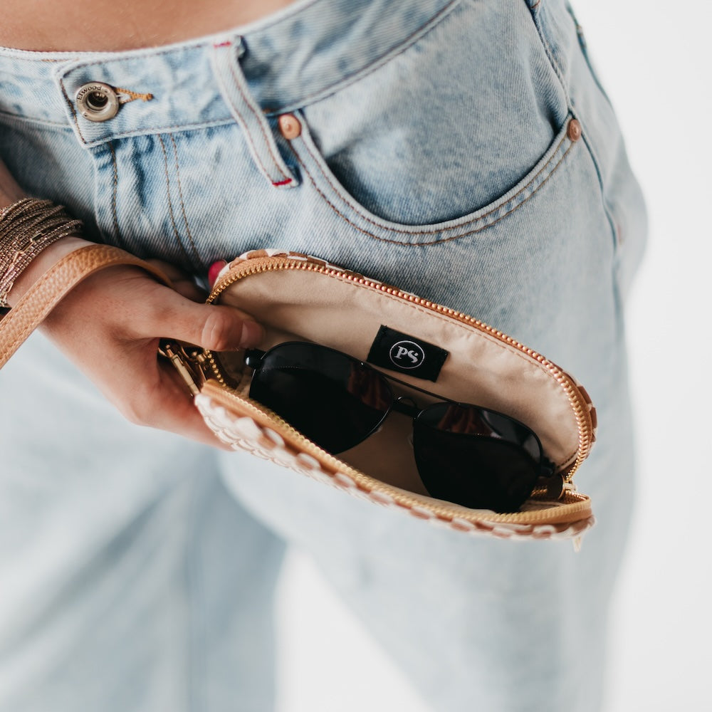 Woven sunglass case wristlet open view with black sunglasses inside