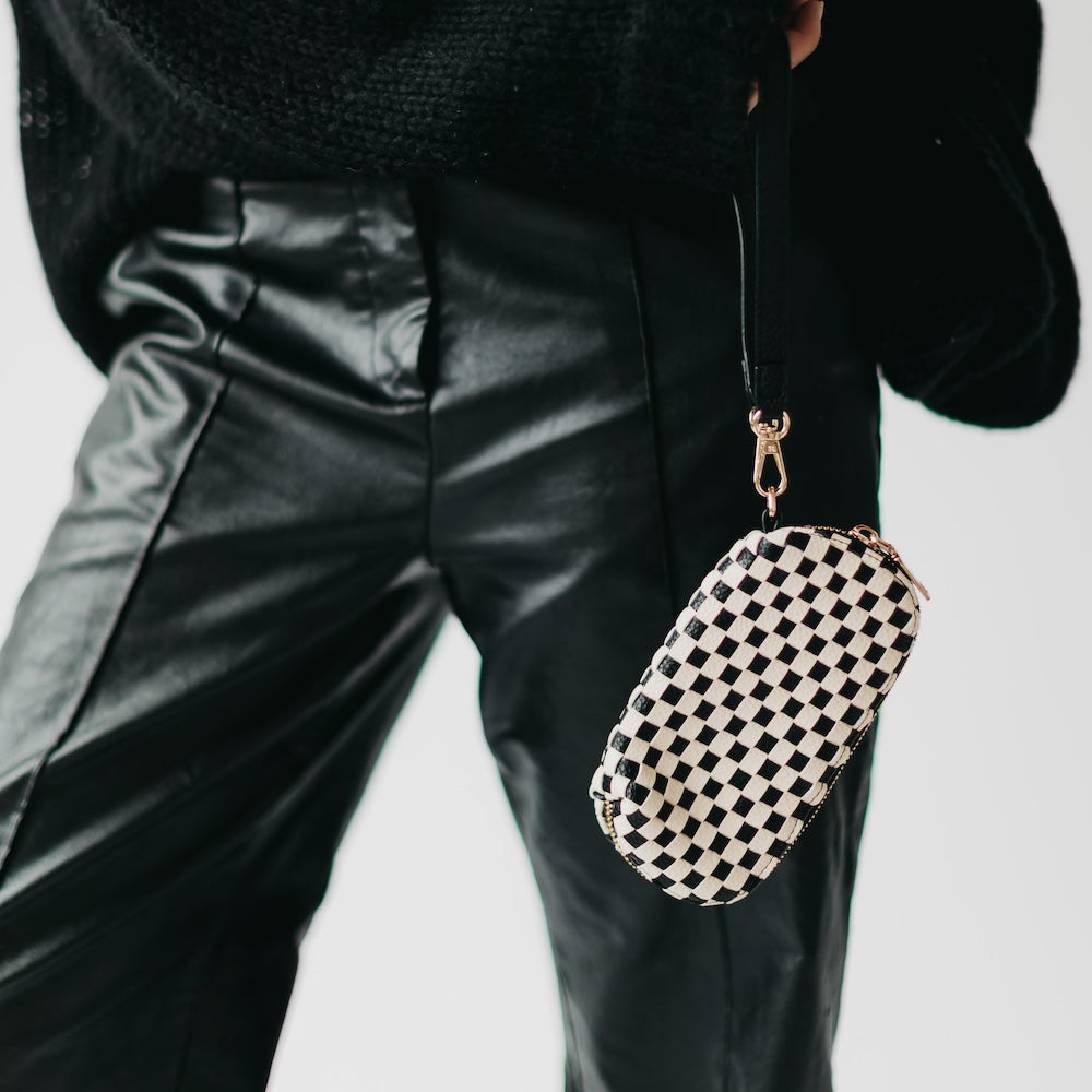 Woven checkered sunglass case wristlet in black and white with gold chain