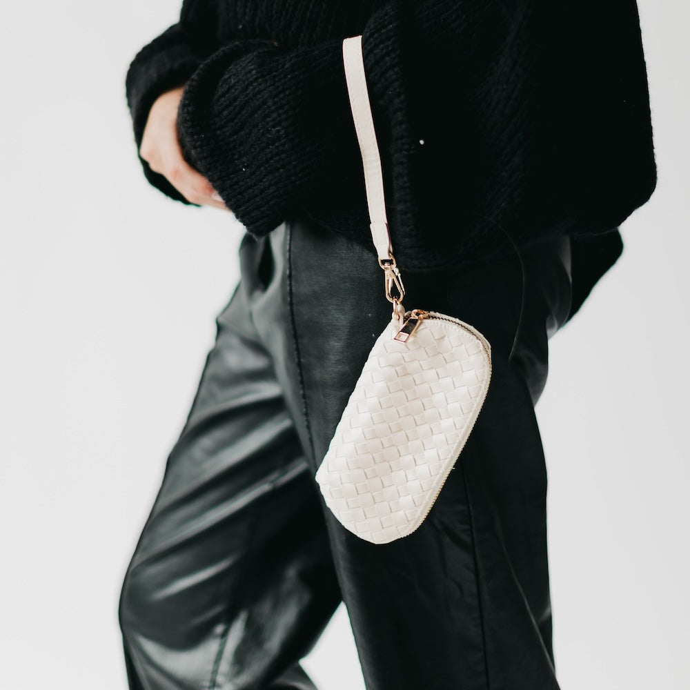 Woven sunglass case wristlet in off-white with wrist strap and gold clasp
