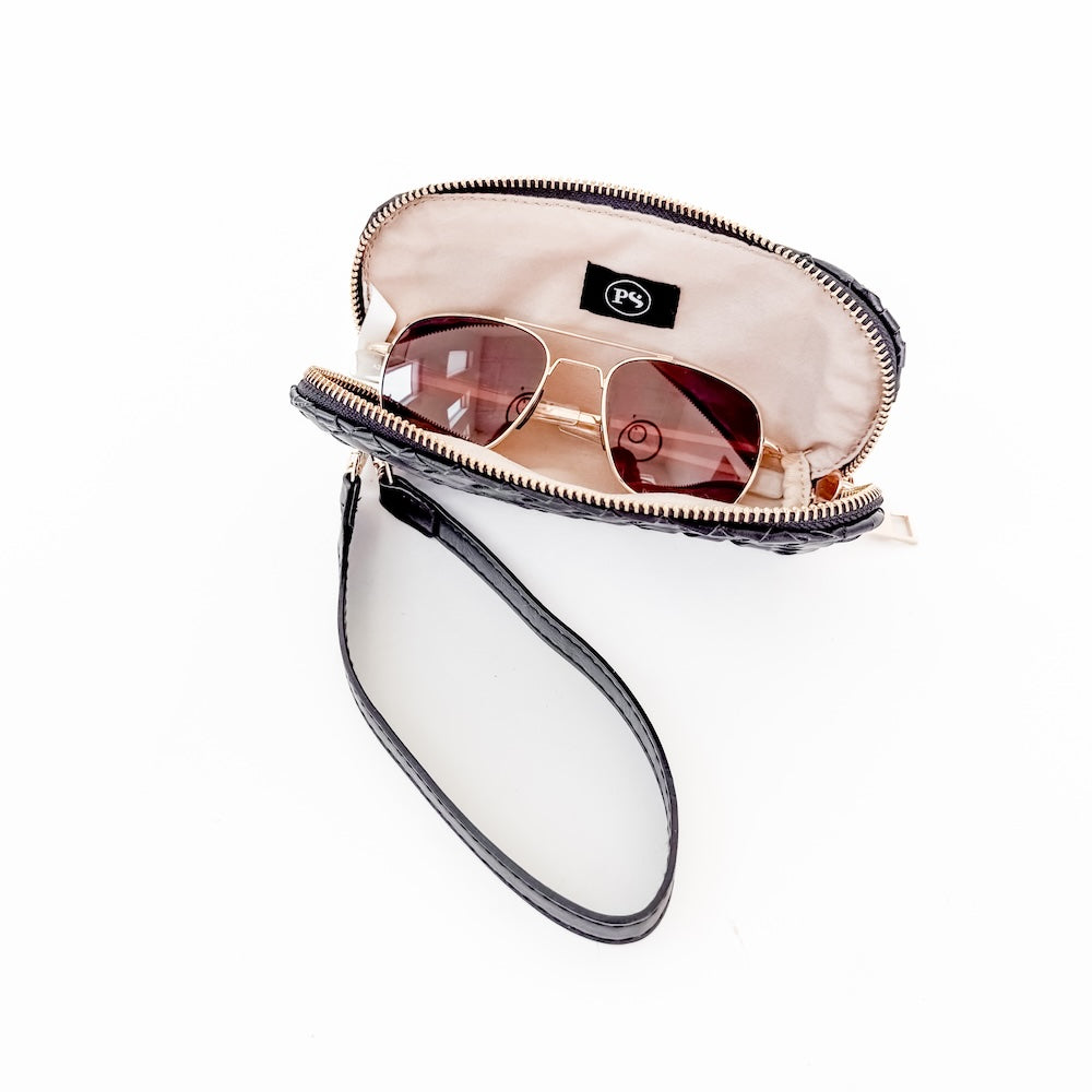 Zipped sunglass wristlet case with sunglasses inside, wrist strap and beige interior
