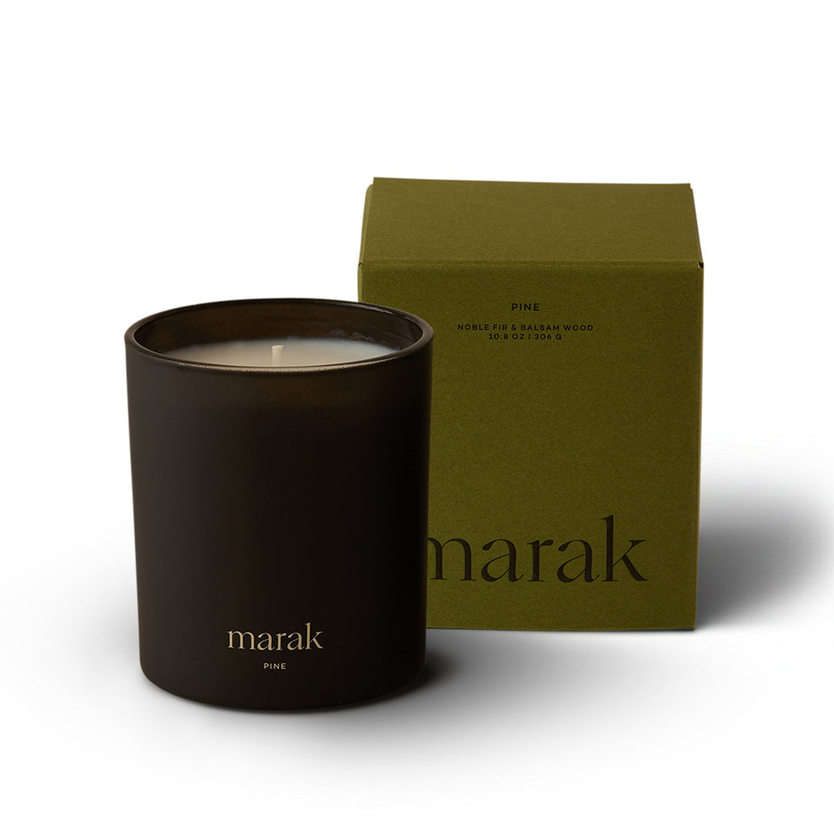 Dark marak pine candle with green box labeled Noble Fir & Balsam Wood