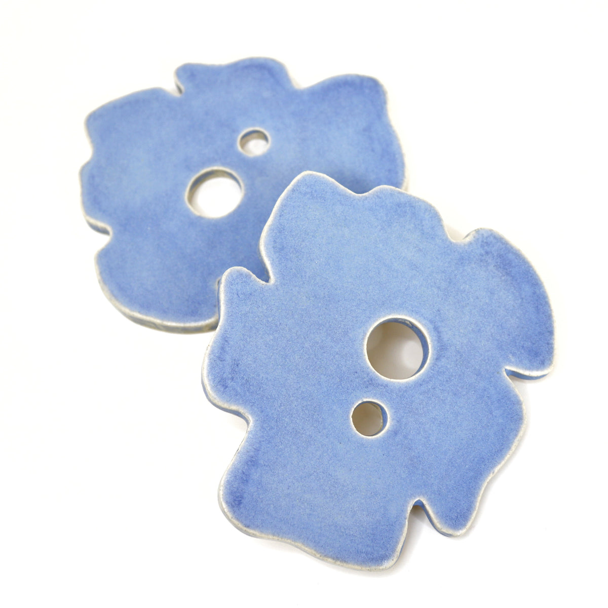 Blue frog-shaped decor piece with three round cutouts and a raised edge