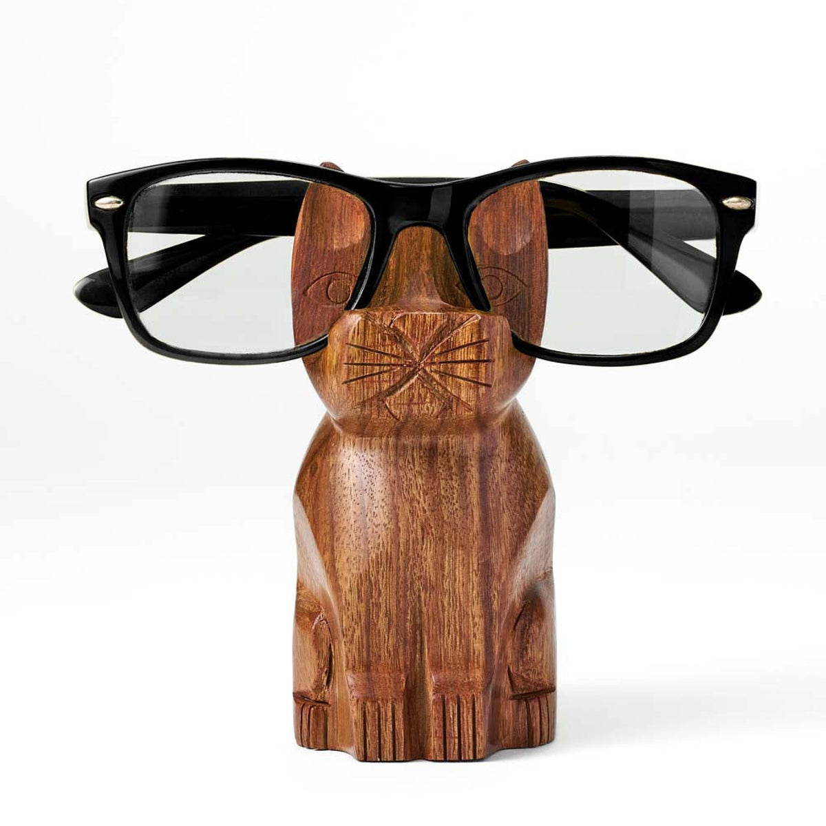 Hand-carved wooden cat eyeglass stand holding black eyeglass frames, centered