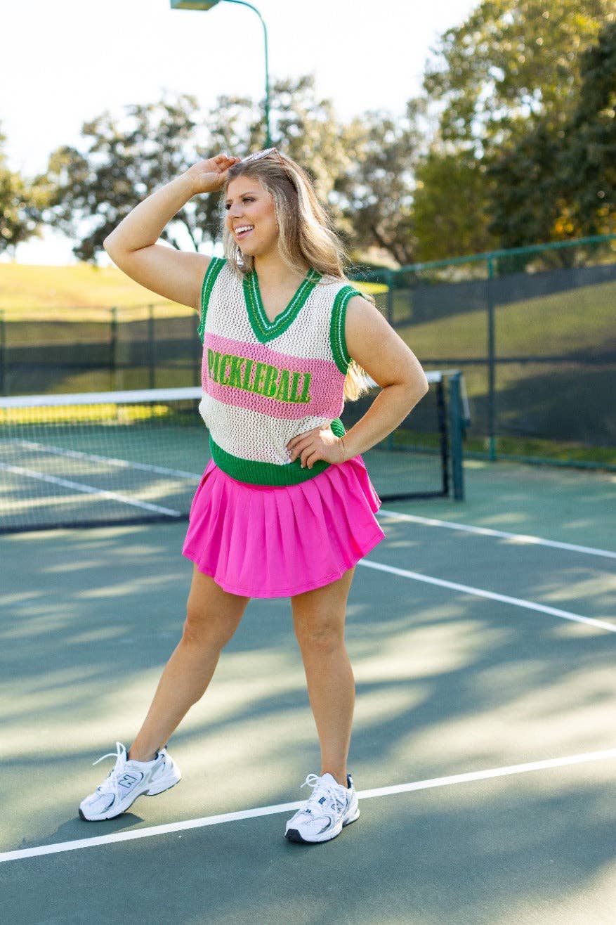 Knit pickleball vest with green armhole trim and a wide green hem