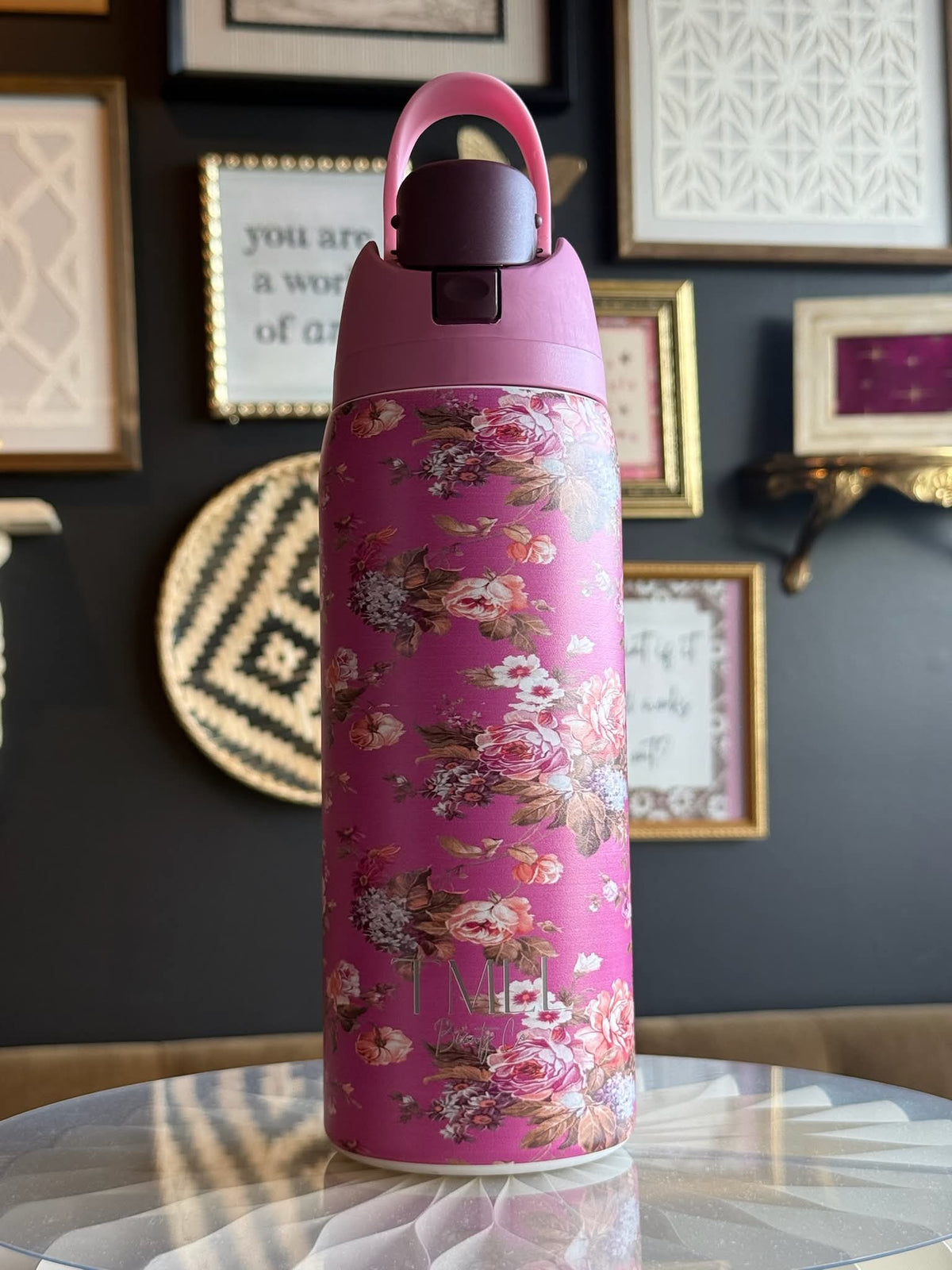 Hot pink floral insulated bottle with black flip-top lid