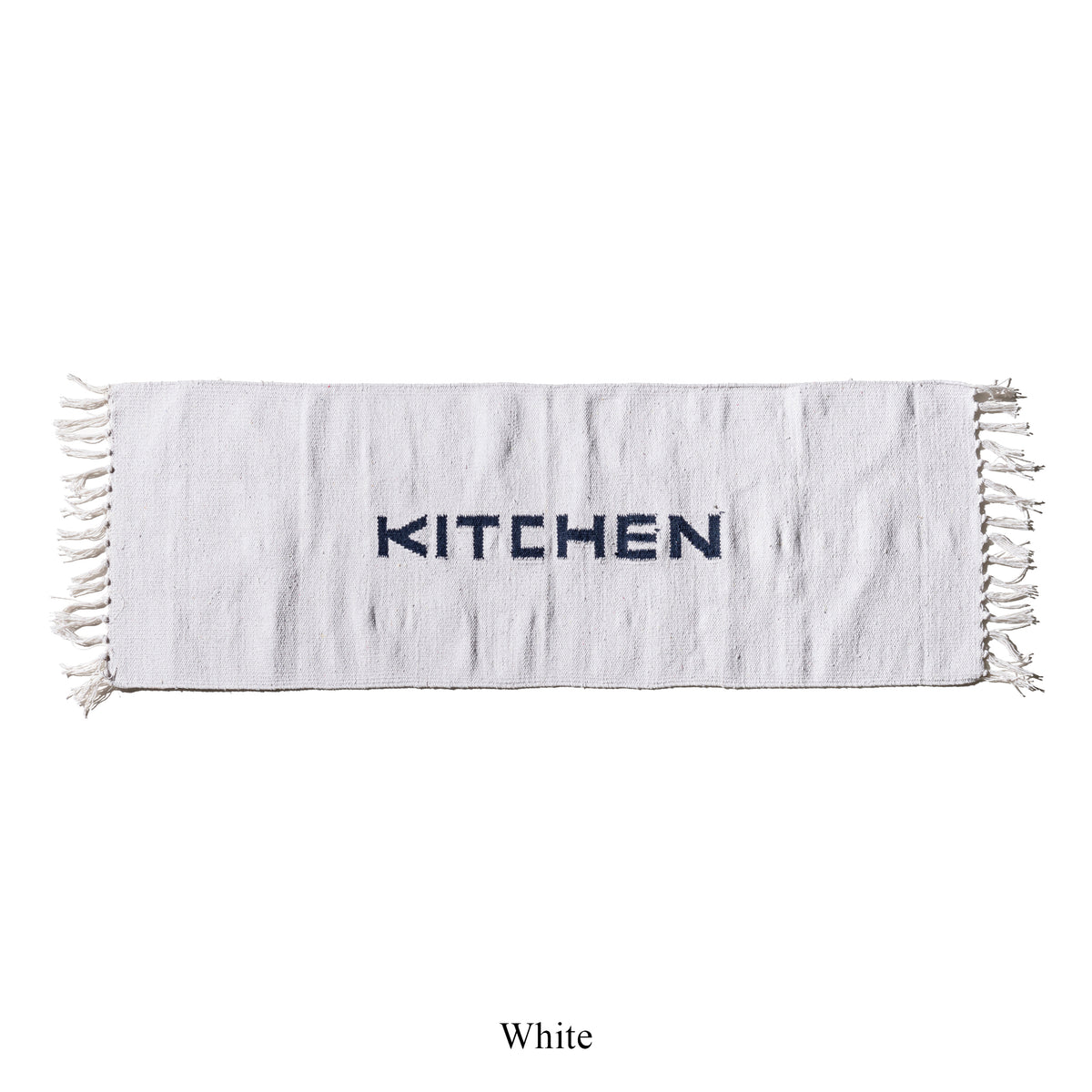 White kitchen mat with fringe edges and black 'KITCHEN' lettering