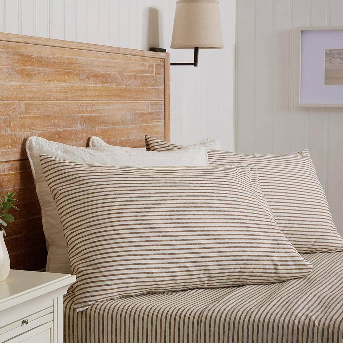 Striped microfiber sheet set on bed, white with green pin stripes and pillows