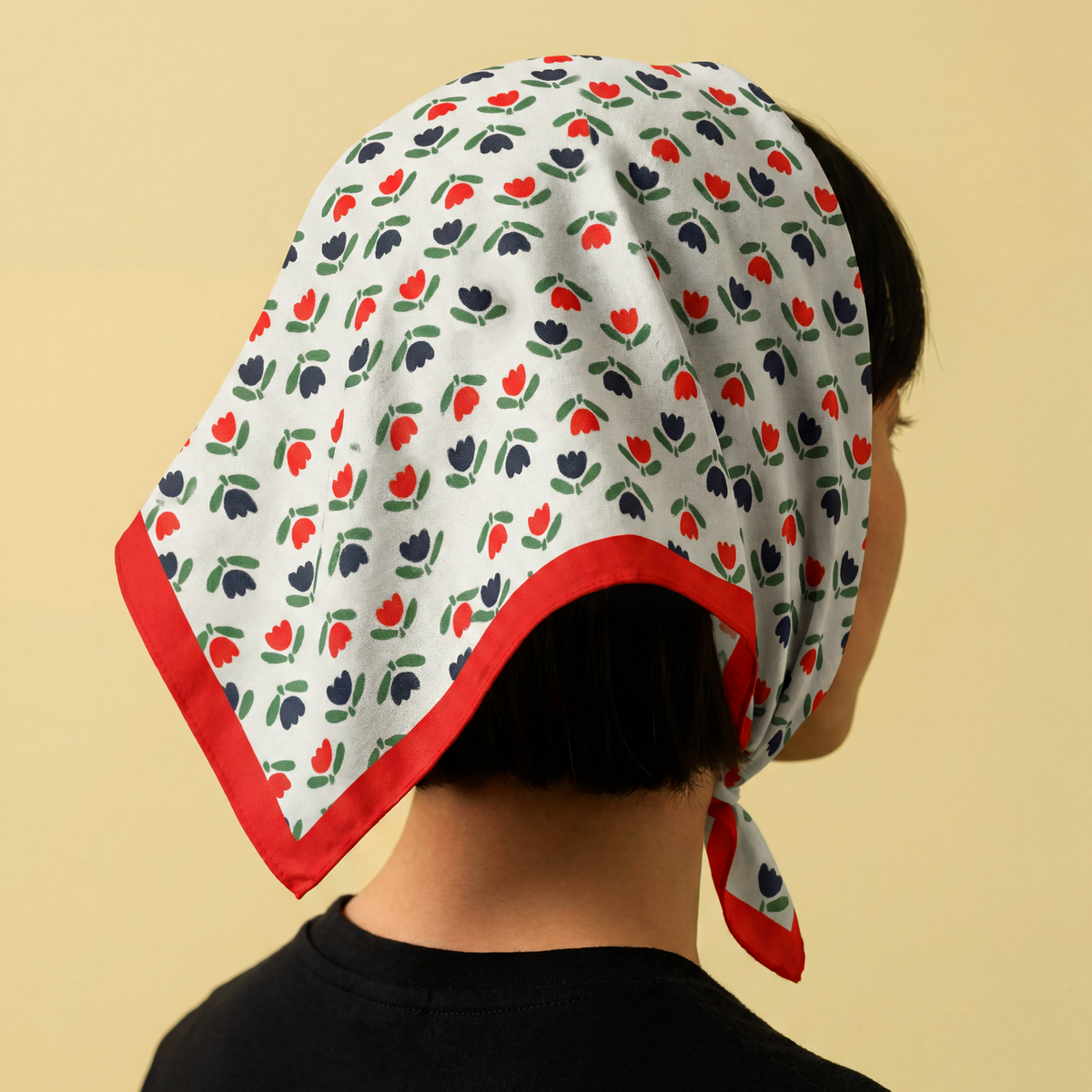 Cotton bandana worn as headscarf, white with red tulip print and red edge