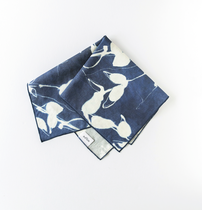 Indigo napkin set with white Porto floral print, neatly folded corner