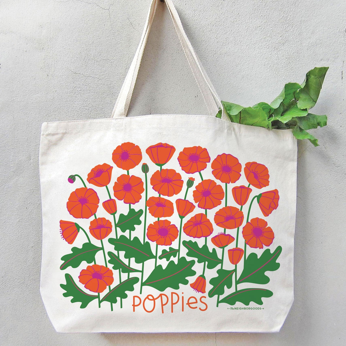 White canvas tote bag with red-orange poppy floral graphic and “Poppies” text.