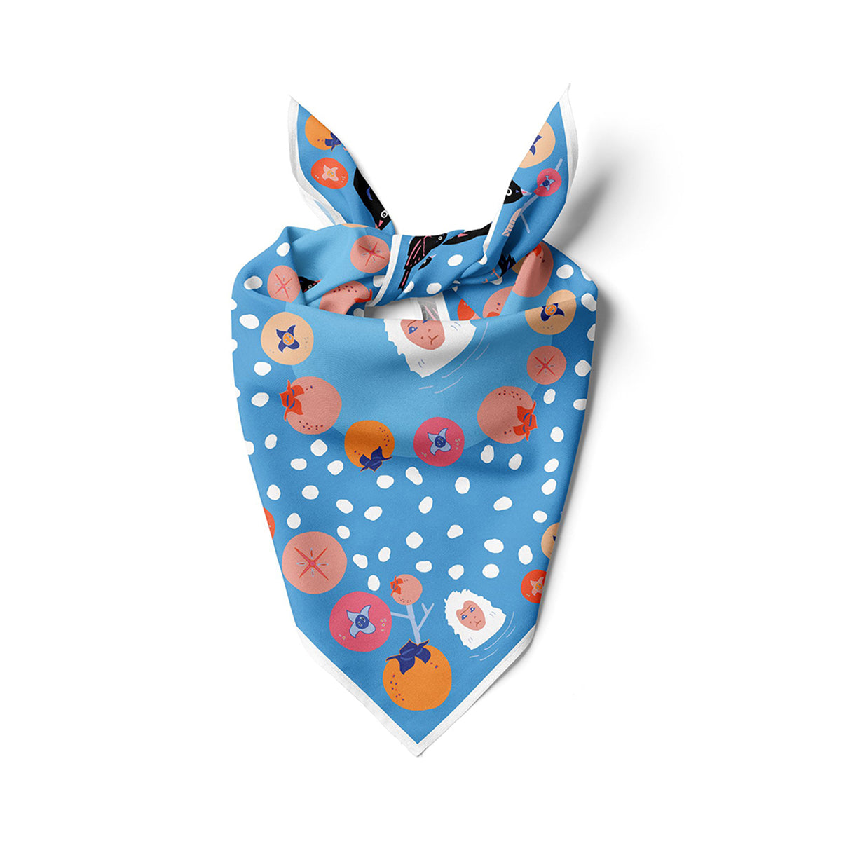 Blue bandana folded into triangle with knot, featuring white dots and animal fruit prints