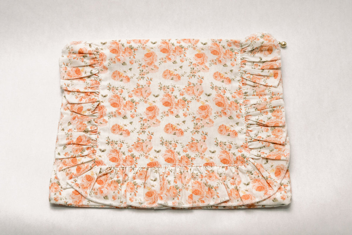 Floral ruffle zipper pouch, coral and orange blooms on light background with ruched sides