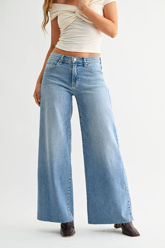 Light wash stretch wide-leg jeans with five-pocket styling and button-zip front