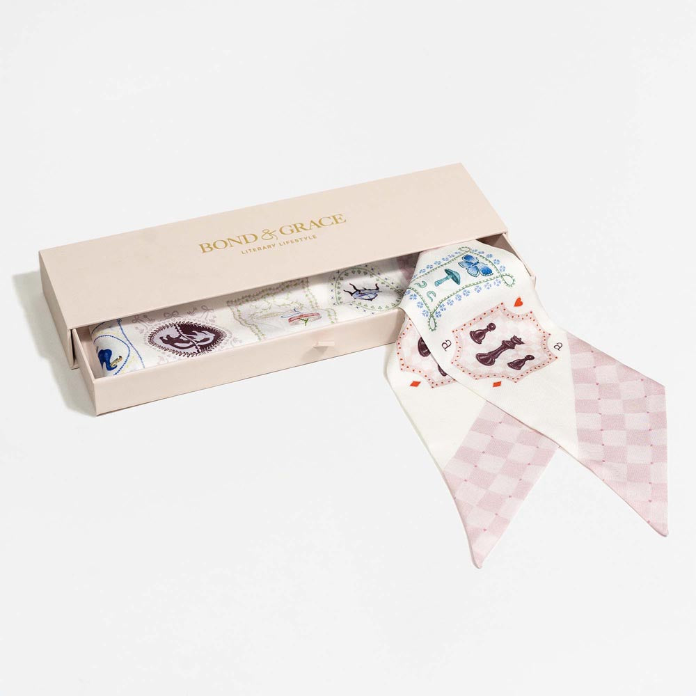 Silk twilly scarf with cream playing-card print and pale pink check panels, laid in box