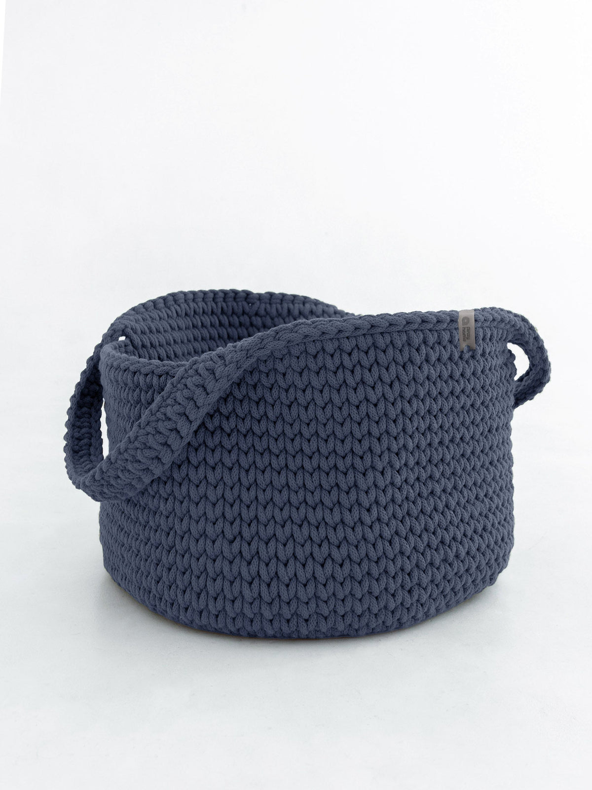 Round knitted storage basket with handles in dark navy blue, close-knit texture