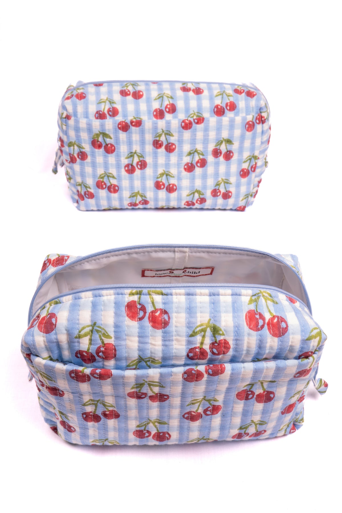 Zippered cherry-print makeup bag with light interior lining, front and open view