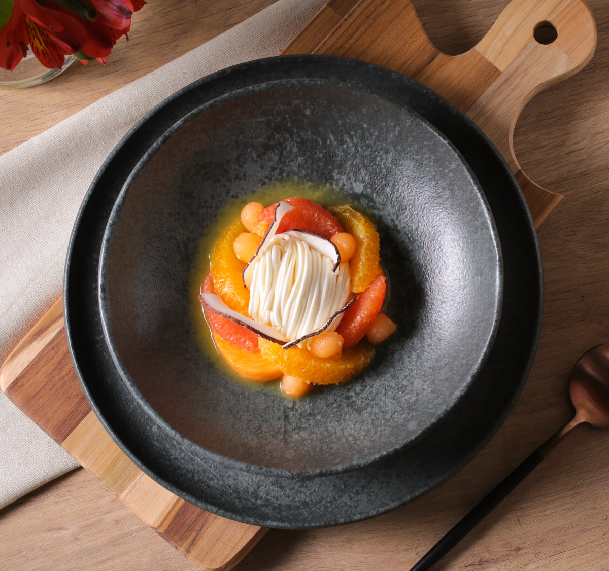 Black reactive-glaze pasta plate with speckled interior, wide low rim