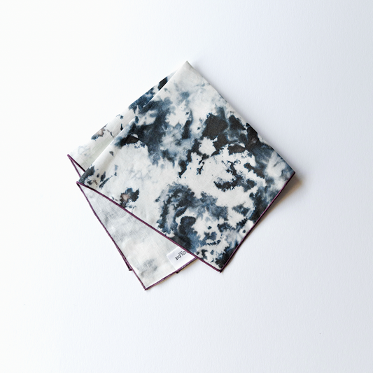 Marble-print napkins with plum edging, white with dark blue-gray abstract pattern