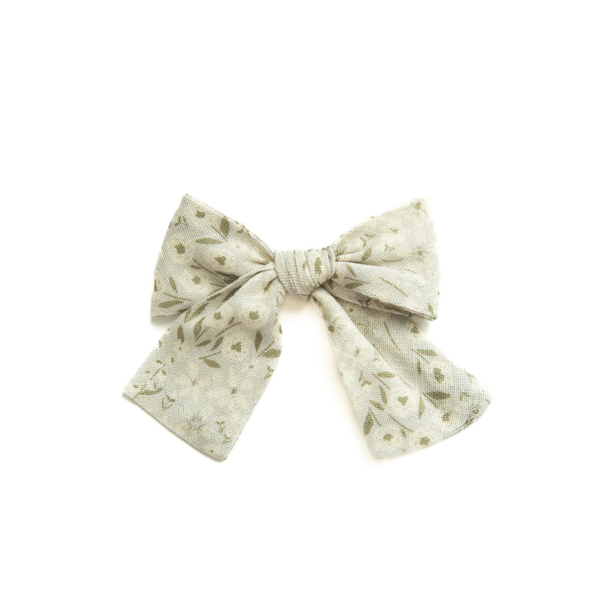 Eden petite hair bow in cream with small green leaf print, tied bow design