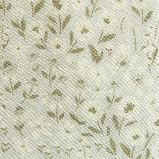 Close-up cream hair sash fabric with small green floral sprig pattern