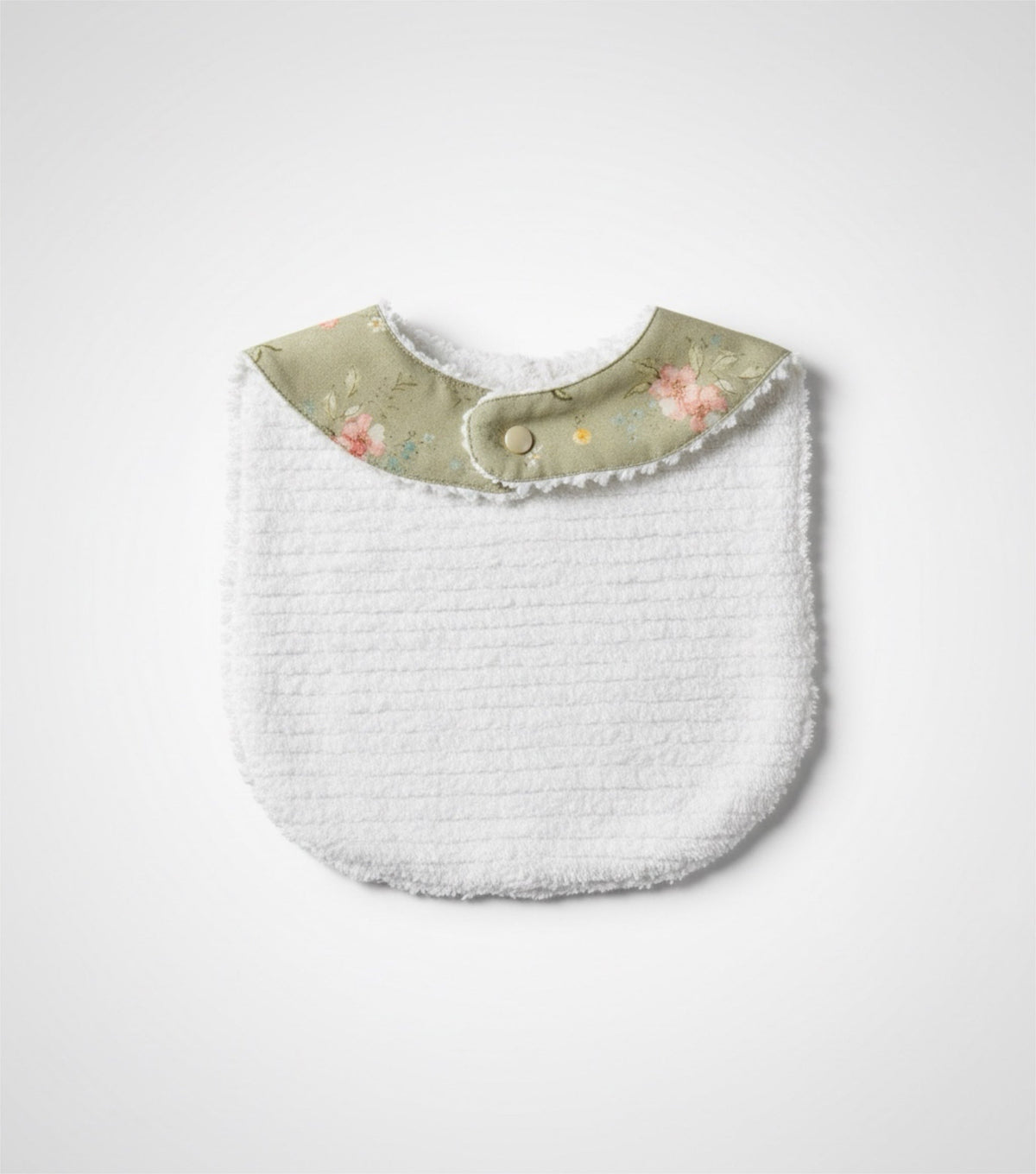 Infant bib with white textured back and sage floral neck band with snap