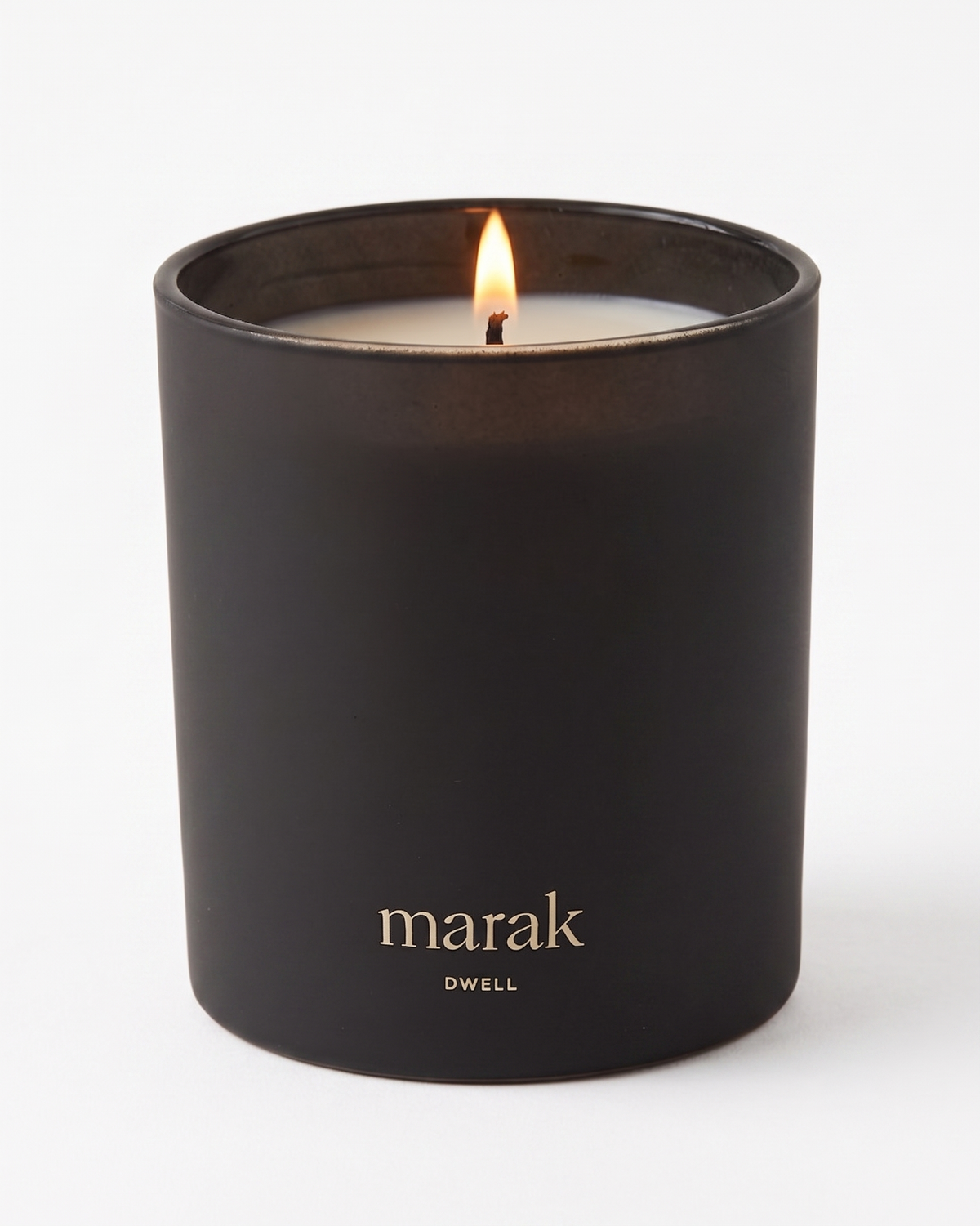 Black marak candle jar with lit flame