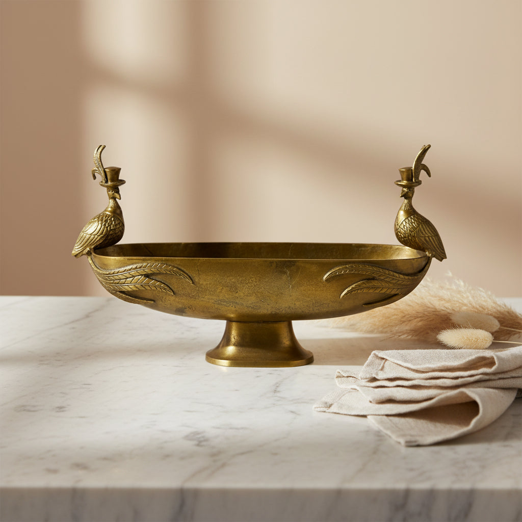 Decorative gold-tone footed bowl with bird finials on raised handles