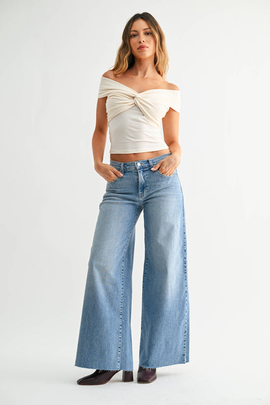 Light wash stretch wide-leg jeans with belt loops, front pockets, and button closure