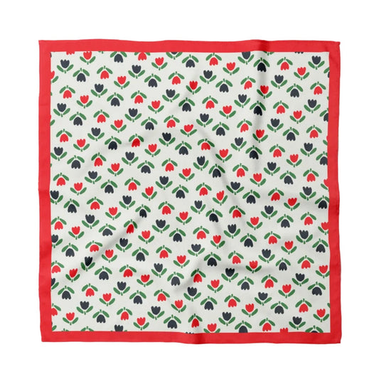 Cotton bandana with white tulip pattern and red border, folded flat
