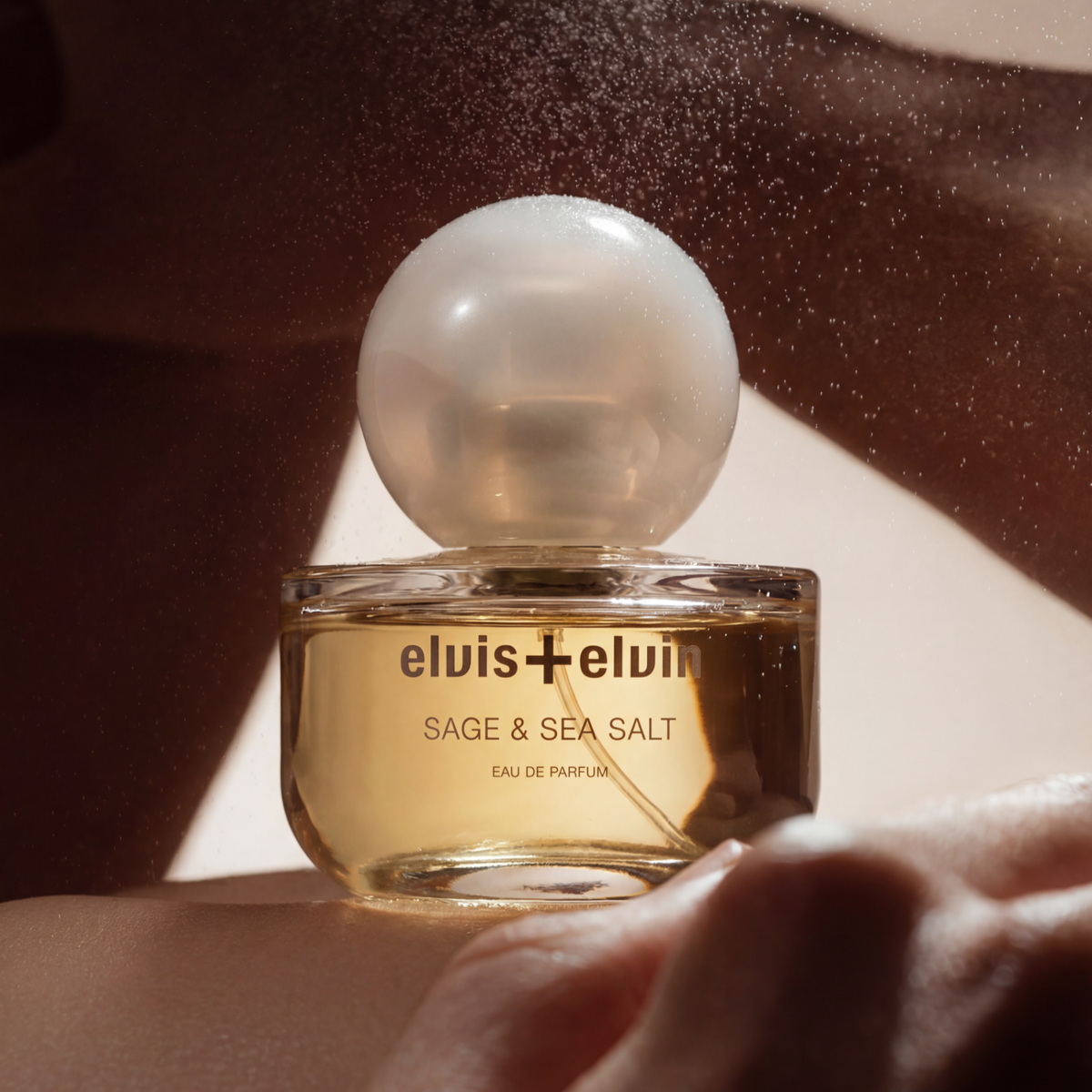 elvis+elvin Sage & Sea Salt eau de parfum bottle with gold label and frosted round dome cap
