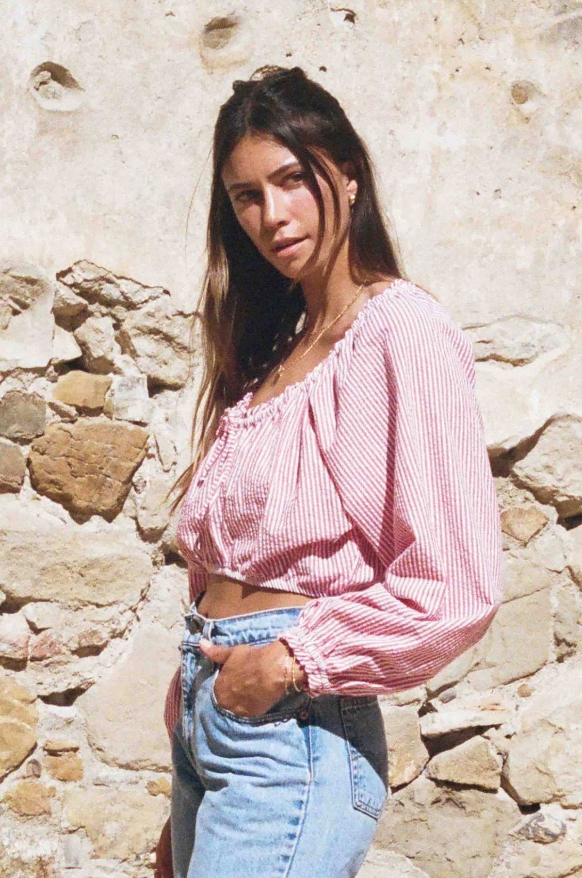 Red-and-white striped seersucker peasant top with off-shoulder neckline and long puff sleeves