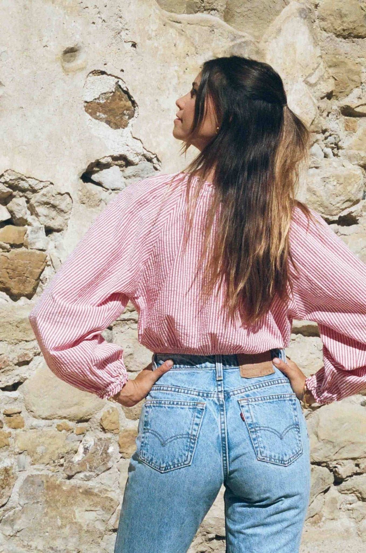 Red-and-white striped seersucker peasant blouse with off-shoulder neckline and gathered details