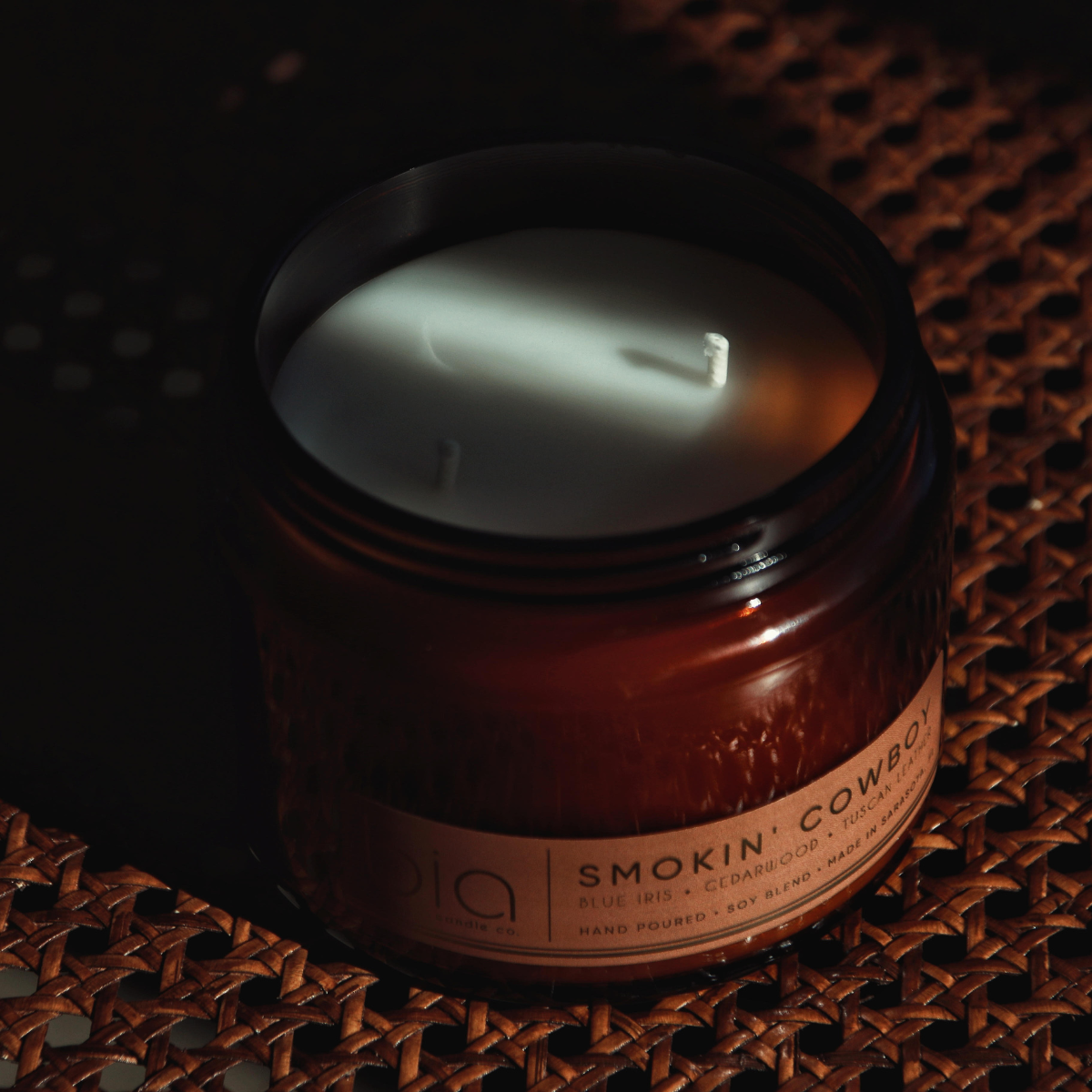 Amber glass candle jar with burning top and 'Smokin' Cowboy' label
