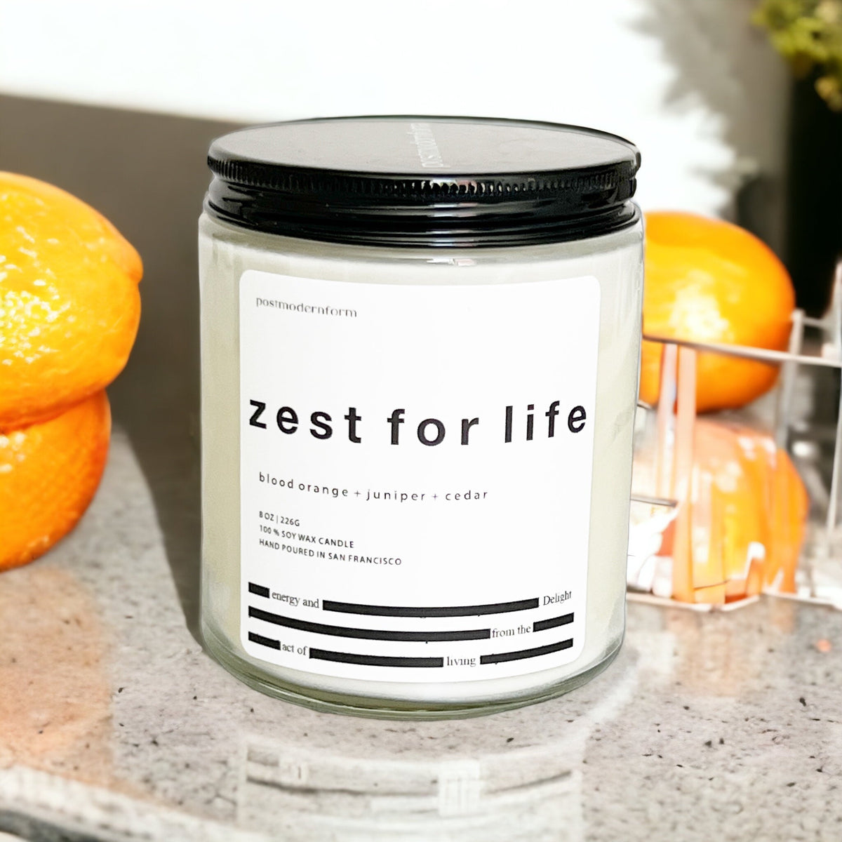 Zest for life candle jar with black lid and front label, close-up