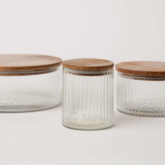 Fluted glass storage jar with wooden lid, ribbed vertical sides