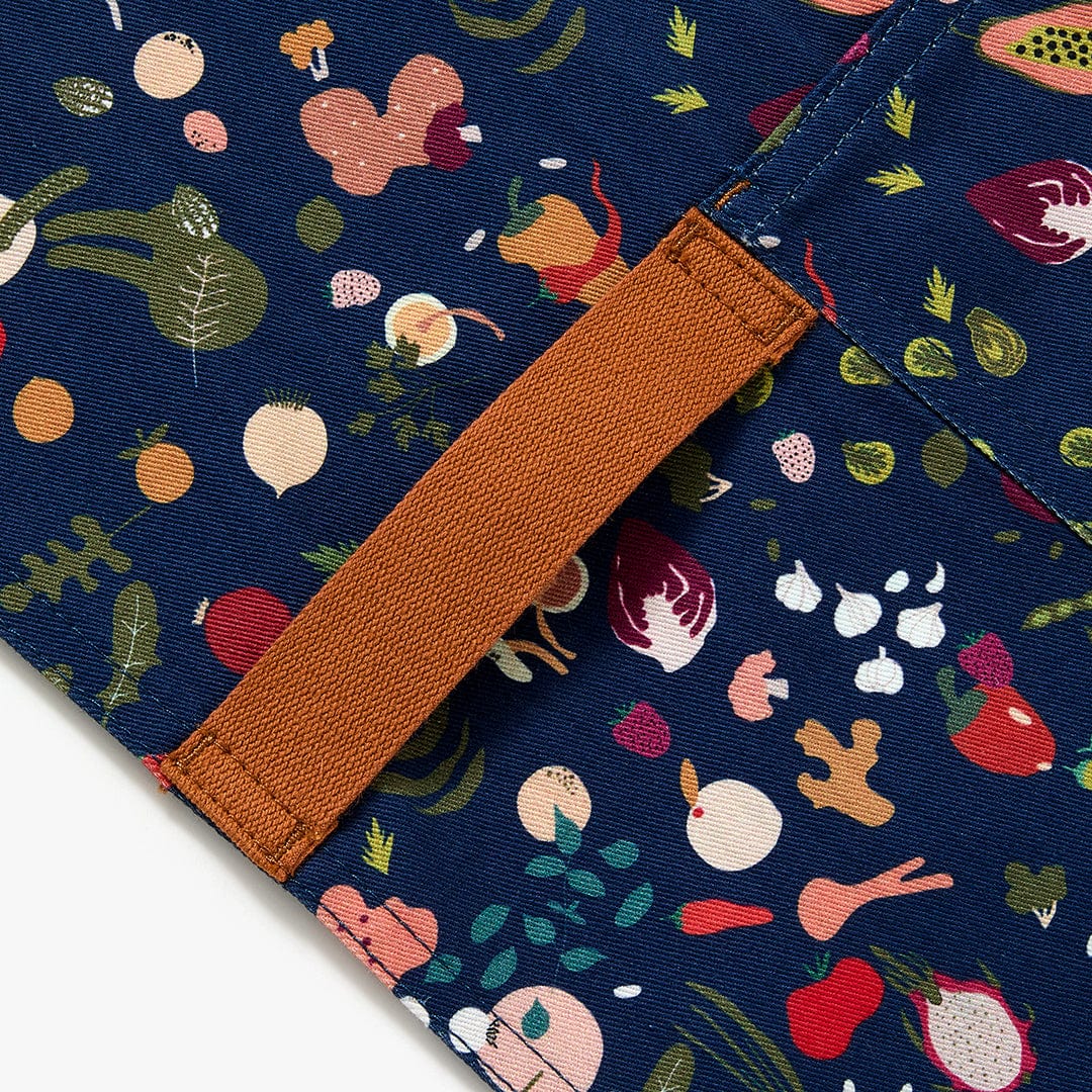 Navy floral apron with orange webbing strap and reinforced edge stitching