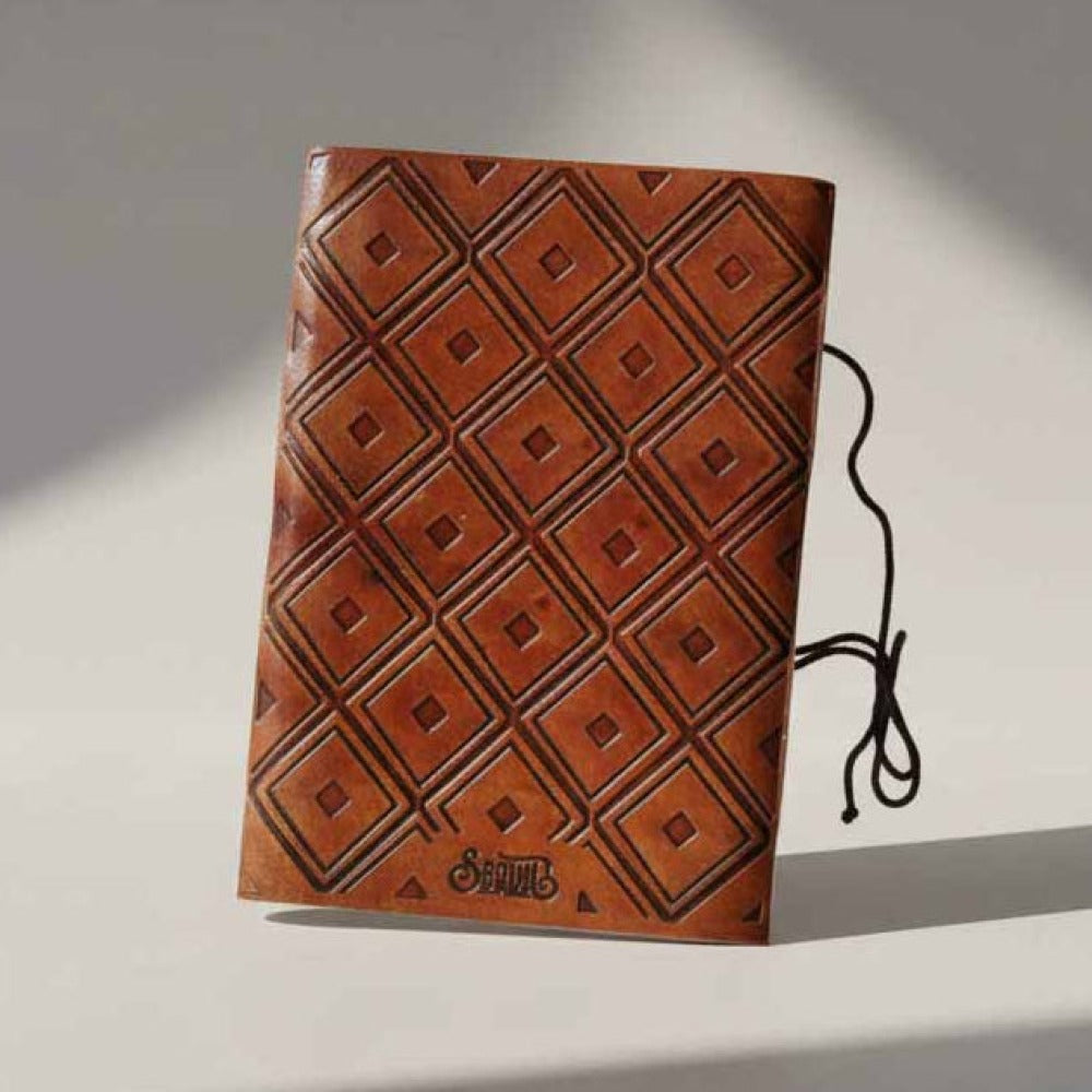 Brown leather journal with geometric embossed pattern cover and tied cord