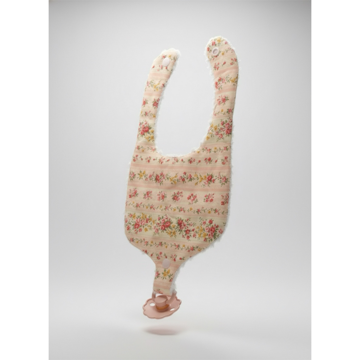 Meadowlark Floral pacifier bib with soft white fuzzy trim and snap attachment