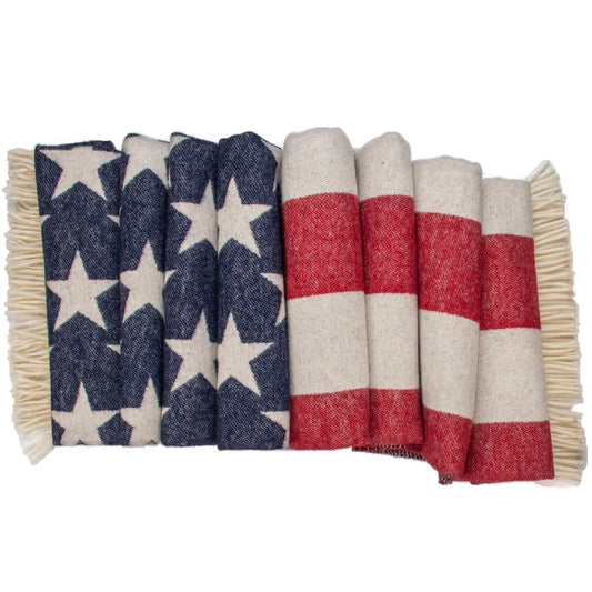 Folded flag throw showing navy star pattern and red-and-white striped panel with fringe