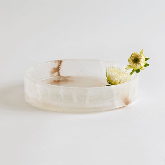Round alabaster vanity tray with frosted clear finish and shallow rim