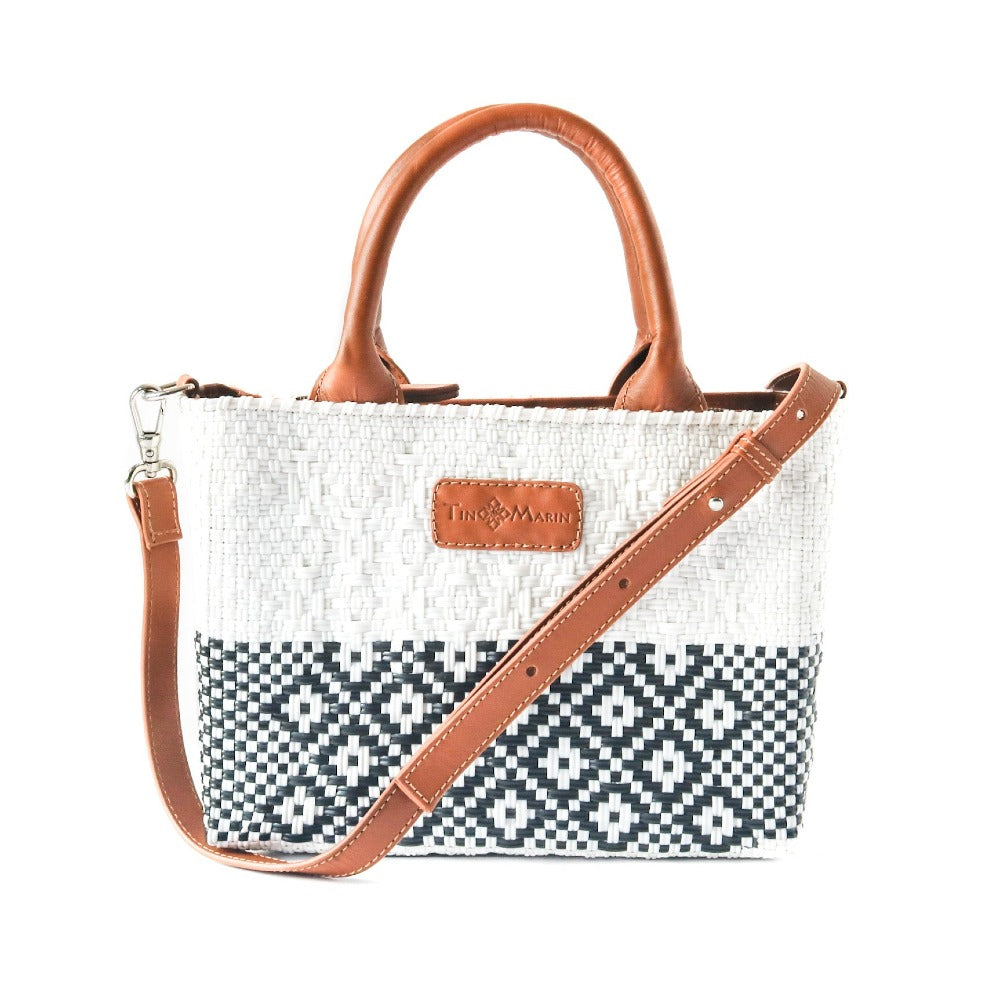 Small woven crossbody bag, white with black geometric pattern and tan leather handles