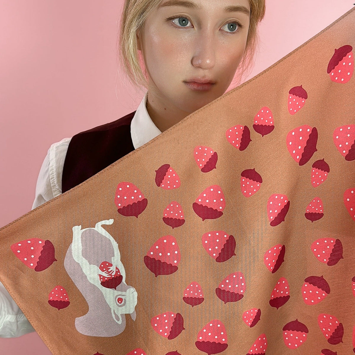 Tan bandana corner with strawberry pattern and white rabbit illustration on one side.
