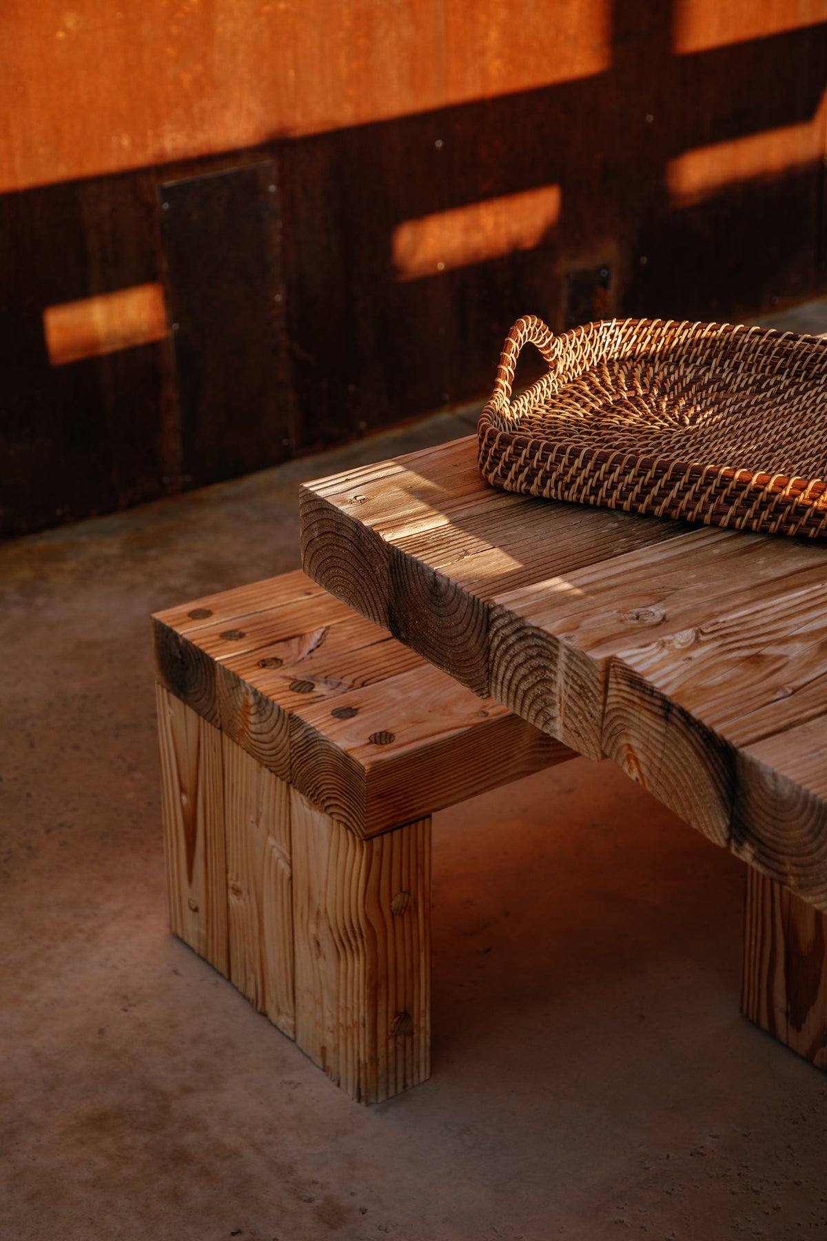 Woven rectangle tray on tabletop, natural and dark brown braided handle